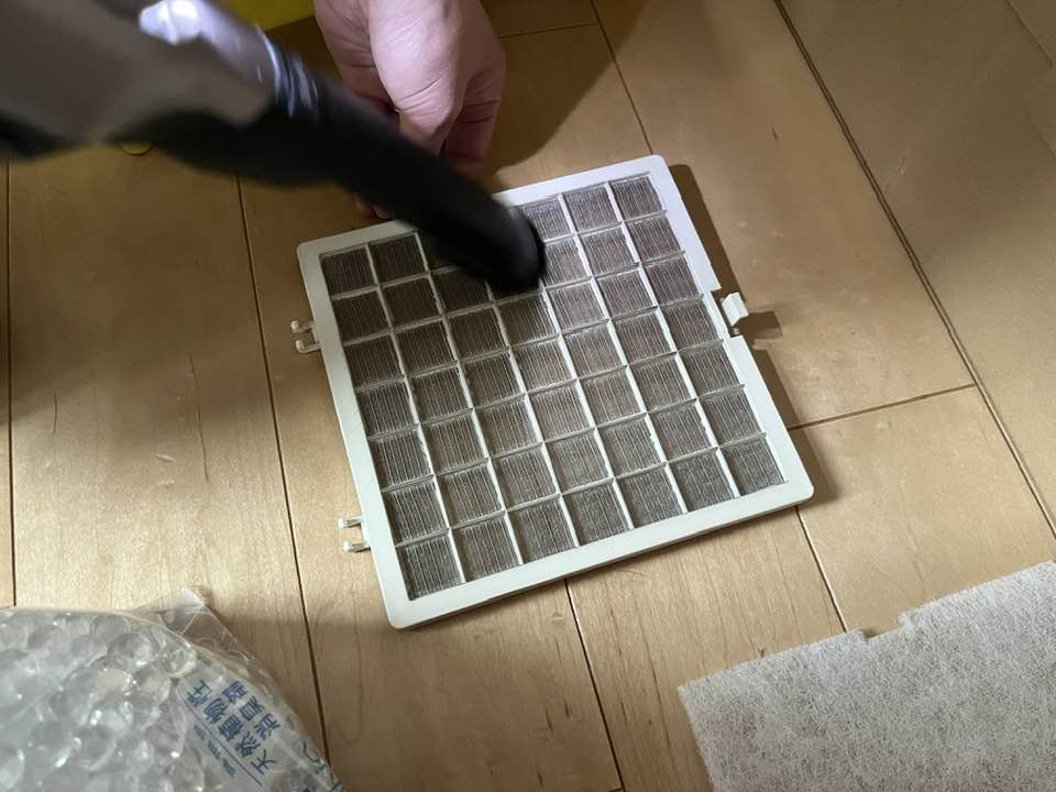 排気フィルターの両面の埃を掃除機で吸う